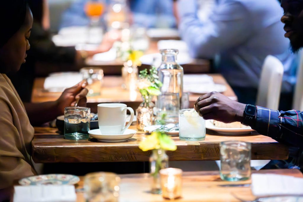 Two guests enjoy a meal at the Guild House.